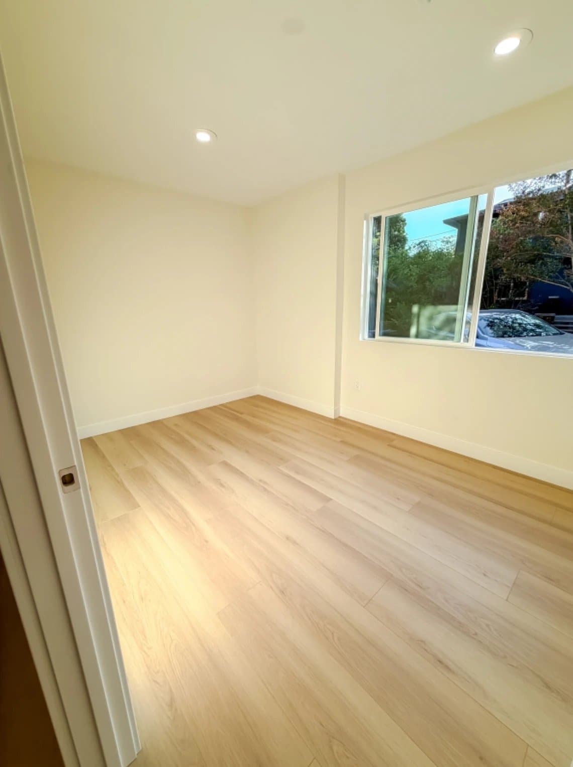ADU bedroom with brand-new flooring and garden window