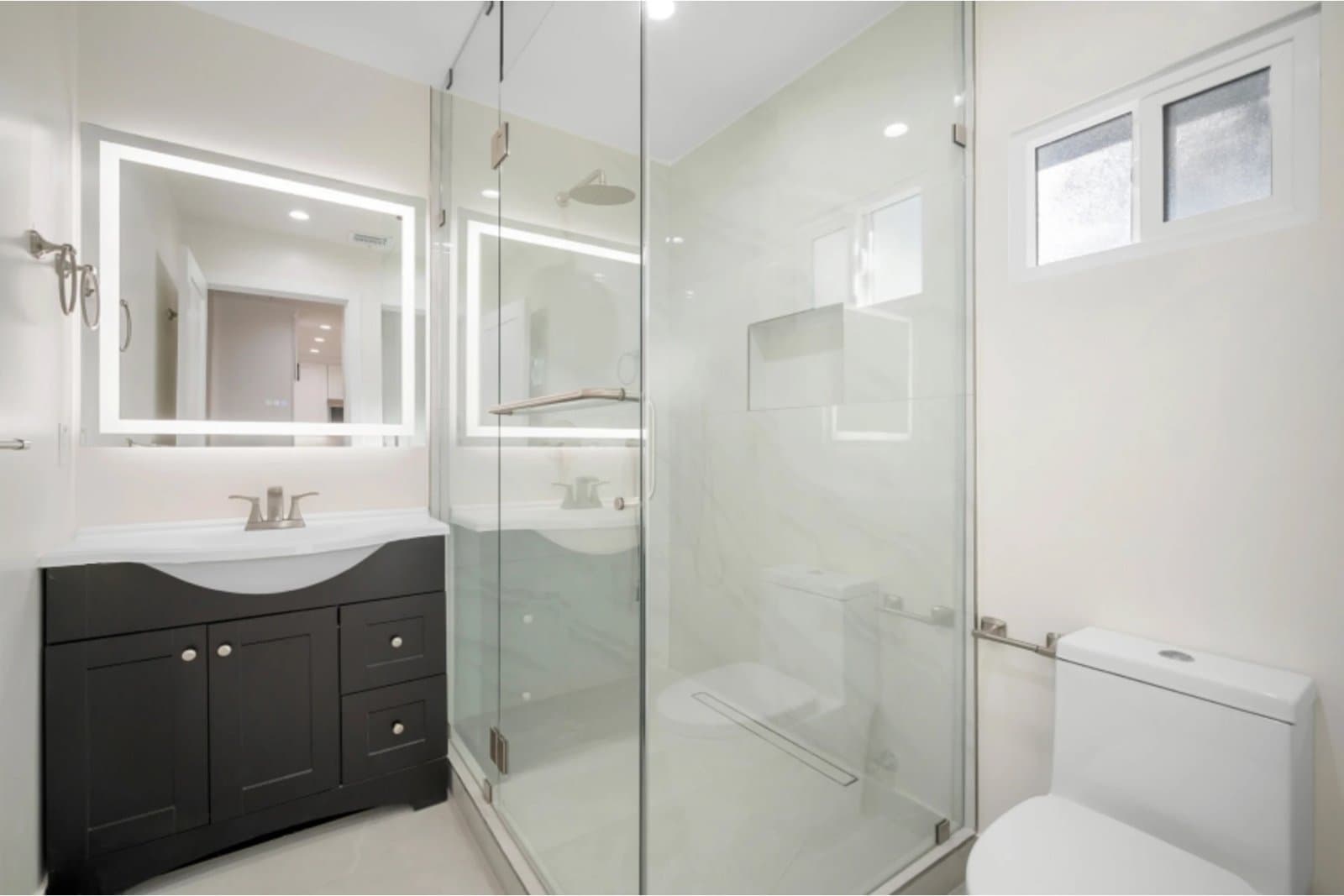 New ADU bathroom with glass shower and LED mirror