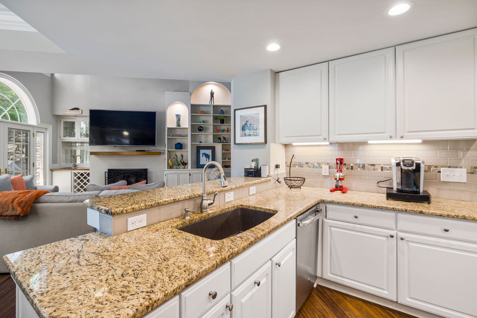 Compact kitchen with granite counters, typical for a JADU efficiency kitchen
